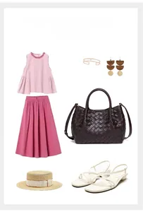 Flat lay of woven leather handbag styled with a pink pleated outfit and summer accessories