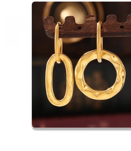 Detailed view of asymmetric gold geometric earrings with a unique hammered texture finish