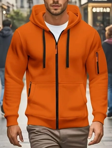 Close-up of orange zip-up hoodie featuring a functional decorative sleeve pocket detail