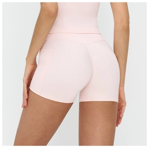 Close-up of light pink high-waisted yoga shorts with seamless contour and lift design