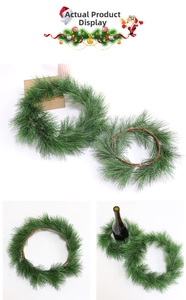 Detail of green artificial PVC pine needle wreath with rustic brown rattan base for holiday