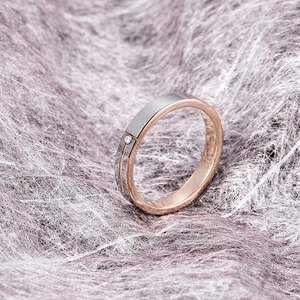 Macro side view of dual-tone tungsten ring with brushed metal texture and inset diamond