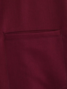 Detailed macro view of twill cotton fabric texture and stitching on dark red jacket pocket