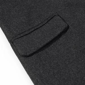 Close-up of the pocket detail and wool texture on a dark grey French style coat