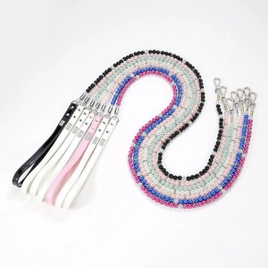 Detail of colorful pearl pet leashes with sparkling rhinestone spacers and leather handles