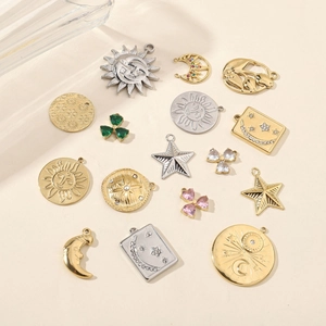 Polished stainless steel celestial pendants with sun moon and star motifs in gold and silver