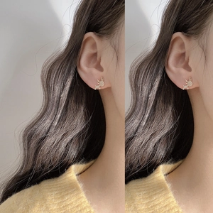 Elegant gold reindeer stud earrings with sparkling rhinestones on model side profile