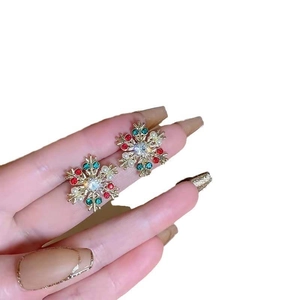 Elegant gold snowflake stud earrings with vibrant red, green, and clear crystals for women