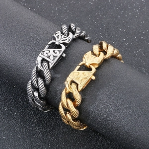 Macro shot of 18k gold and silver steel curb chains with engraved baroque floral clasps