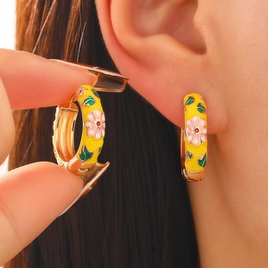 Macro shot of retro Chinese style enamel hoop earrings with pink floral patterns