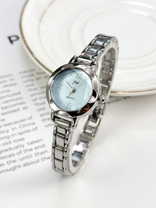 Detail of vintage silver quartz watch with a light blue dial and Roman numerals markers