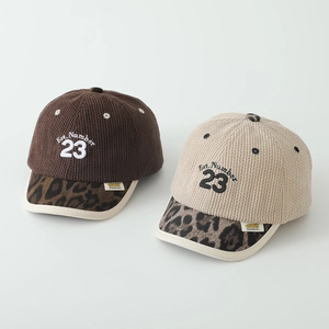 Detail of corduroy kids baseball cap with leopard print brim and Number 23 embroidery