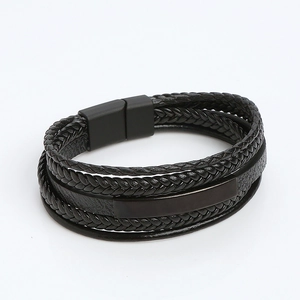 Macro detail of men's double-layer braided leather bracelet with black magnetic metal clasp