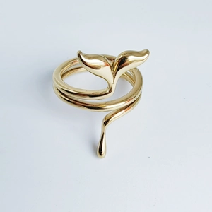 Gold stainless steel twisted ring featuring a unique whale tail and fluid droplet design