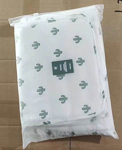 Close-up of white waterproof travel bag with cactus print in a matte zipper pouch