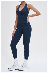 Detail of navy blue halter yoga set showing cross-neck top and high waist leggings