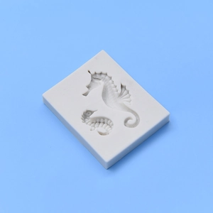 Seahorse silicone mold for fondant and chocolate cake decoration on blue background