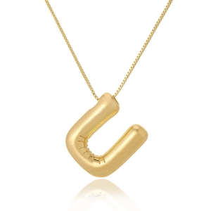 Close-up of golden balloon-style 3D letter U pendant with a polished finish and fine chain