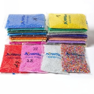 Detailed view of colorful 2mm glass seed beads in transparent packaging for DIY jewelry