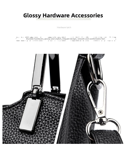 Close-up of glossy silver hardware and lychee grain leather texture on a black handbag