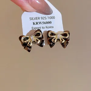 Elegant tortoiseshell bow earrings with 925 silver needles and central zircon stone