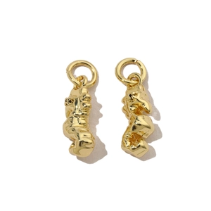 Macro shot of gold plated irregular fluid art charms with high shine metallic finish