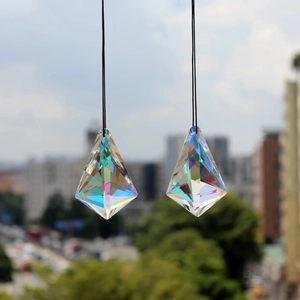 Detailed view of faceted crystal prisms with rainbow reflections and hanging cords