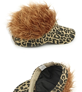 Close-up of leopard print visor cap with brown faux wig and 100% cotton wash label