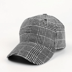 Detailed view of the thick wool fabric texture on a plaid baseball cap for autumn and winter