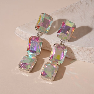 Close-up of sparkling square rhinestone fringe earrings with aurora luster effect