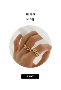 Detail of a gold-plated braided metal ring with a three-strand woven design for women