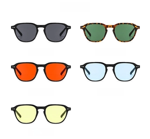 Flat lay of retro small round frame sunglasses in five candy colors with metallic studs