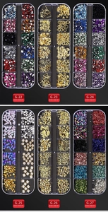 Six 12-grid boxes containing assorted nail art rhinestones, pearls, and metal studs
