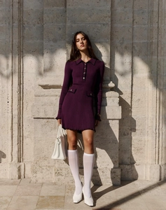 Detail of purple ribbed knit dress featuring a polo collar and double pocket accents