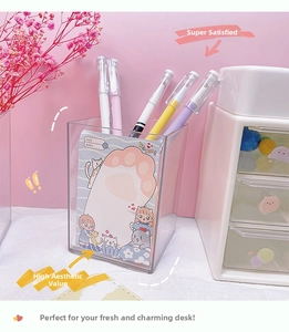 Close-up of clear acrylic pen holder with cat-themed sticky notes and colorful pens