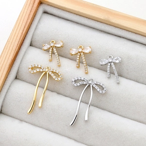 Bow tie jewelry pendants with cubic zirconia inlay in gold and silver finish