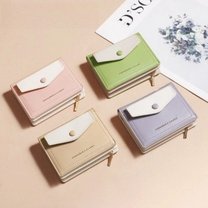 Close-up of diamond quilted accordion card holders in pink, green, beige and purple