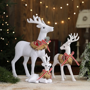 Three-piece set of white flocked Christmas reindeer statues with festive red scarves and bows