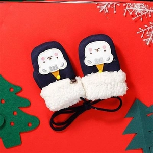 Detail of navy blue baby mittens with fleece trim and bear embroidery on festive background