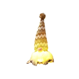 Golden knitted Christmas gnome with LED glowing beard for festive holiday decoration