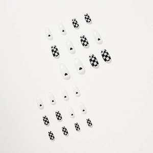 Glossy checkered and heart pattern press-on nails in black and white long oval shape