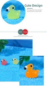 Glow-in-the-dark resin flamingo miniatures on blue sand for micro landscape decor