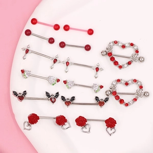 Red heart and rose stainless steel nipple rings set with zircon stones on white tray