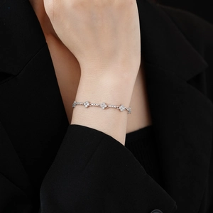 Detail of silver rhombus flower bracelet with cubic zirconia on a model wrist