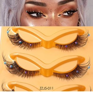Detail of fox-eye false eyelashes with colorful pearl accents and model wear effect
