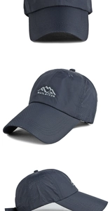Detail of navy blue quick-dry cap with embroidered mountain logo and breathable fabric