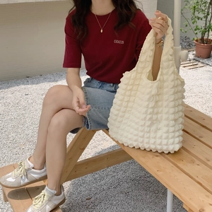 Detail of white bubble textured tote bag with puffy cloud 3D floral pattern texture