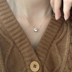 Minimalist 925 sterling silver bean pendant necklace worn on neck for a modern look