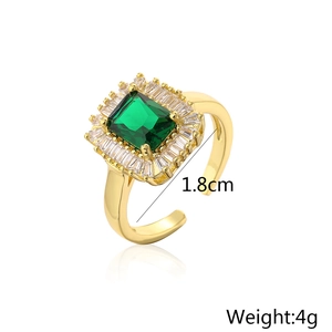 Detail view of gold geometric open ring with emerald green zircon and dimensions