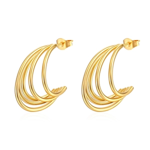 Macro detail of multi-layered curved gold earrings with polished 18K stainless steel texture